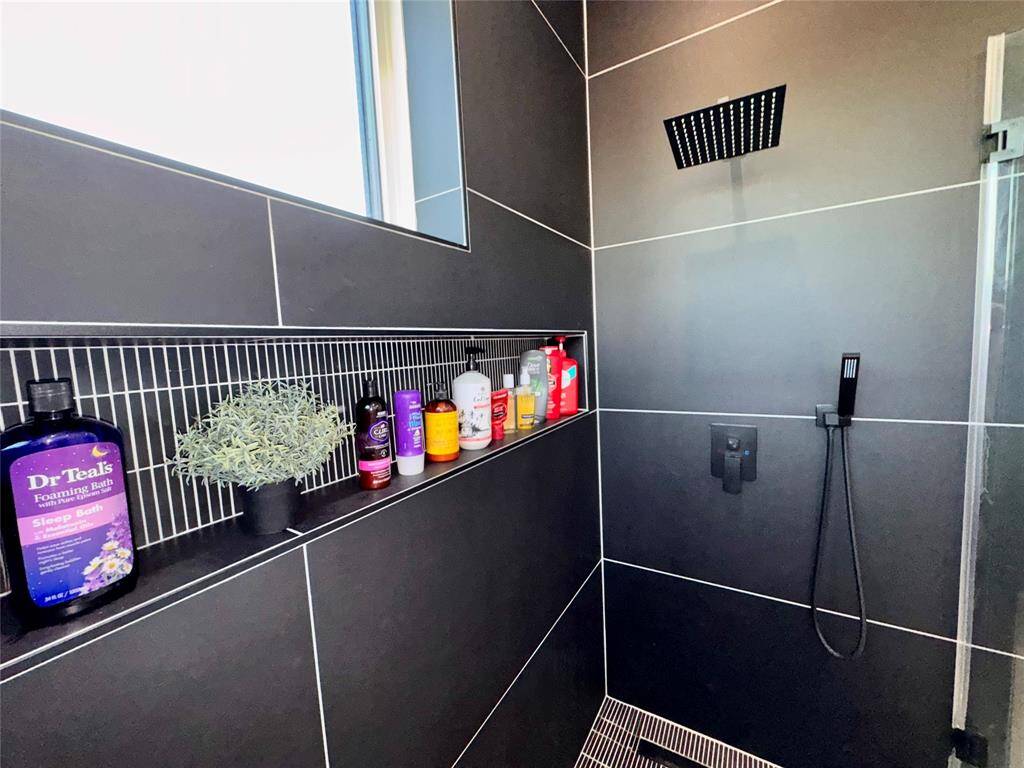 Designer Bathrooms: Swiss Madison one-piece toilets with bidet, rain showers with handhelds and niche storage, plus backlit and front-lit minimalist mirrors—over $5,500 in thoughtful bath upgrades.