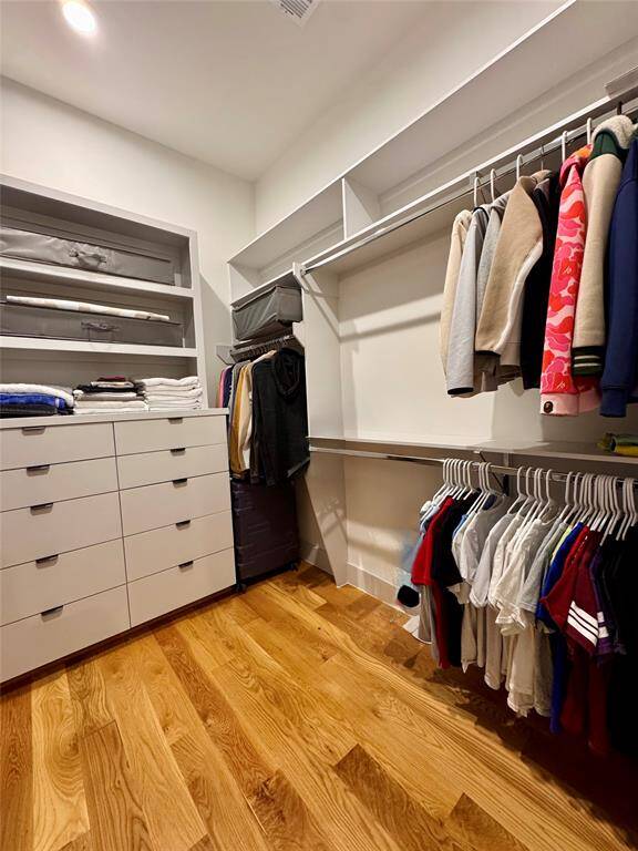 Primary closet with built in soft-closing drawers and electrical outlets for your ironing board!