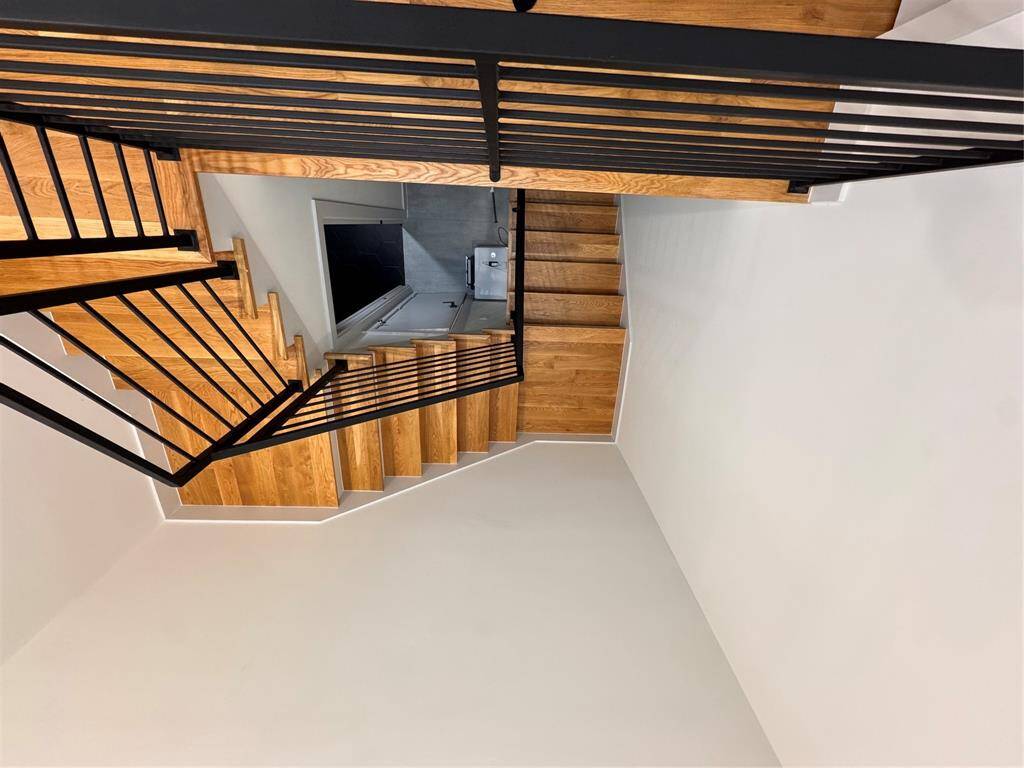 Starcase is open and airy featuring skylight above -