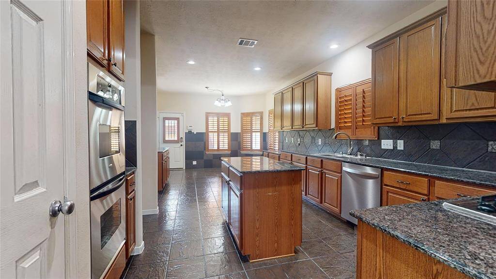 Spacious gourmet kitchen featuring a sleek center island.