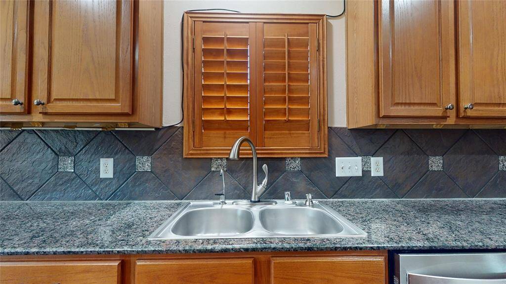 Elegant gourmet kitchen featuring a double sink with a picturesque window view.