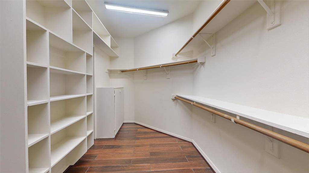 Spacious walk-in closet with ample shelving and hanging space, perfect for organizing your wardrobe.