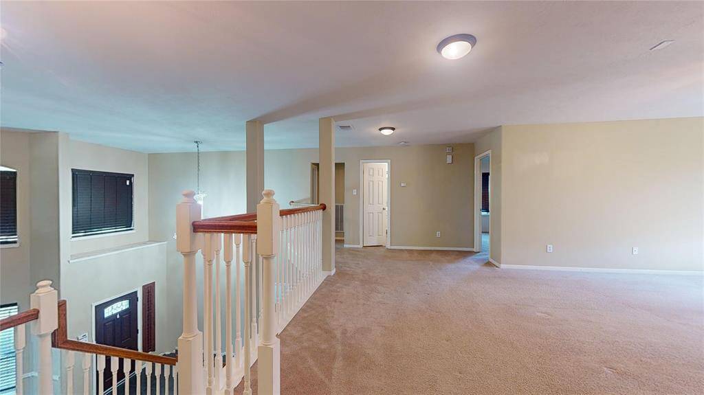 Spacious and versatile upstairs loft, perfect for a home office or cozy retreat.