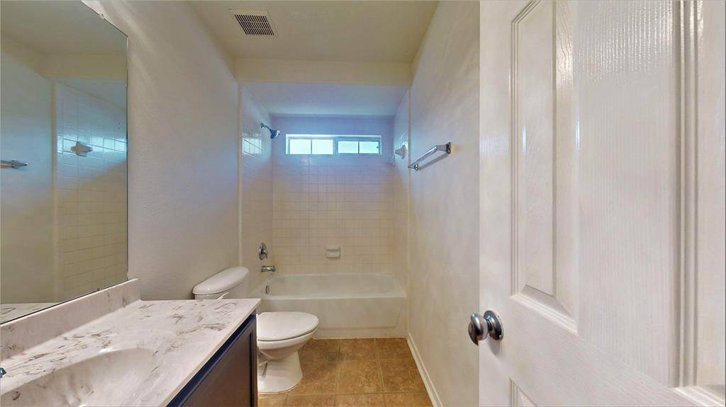 Cozy third guest bathroom located upstairs, featuring modern fixtures and a clean design.