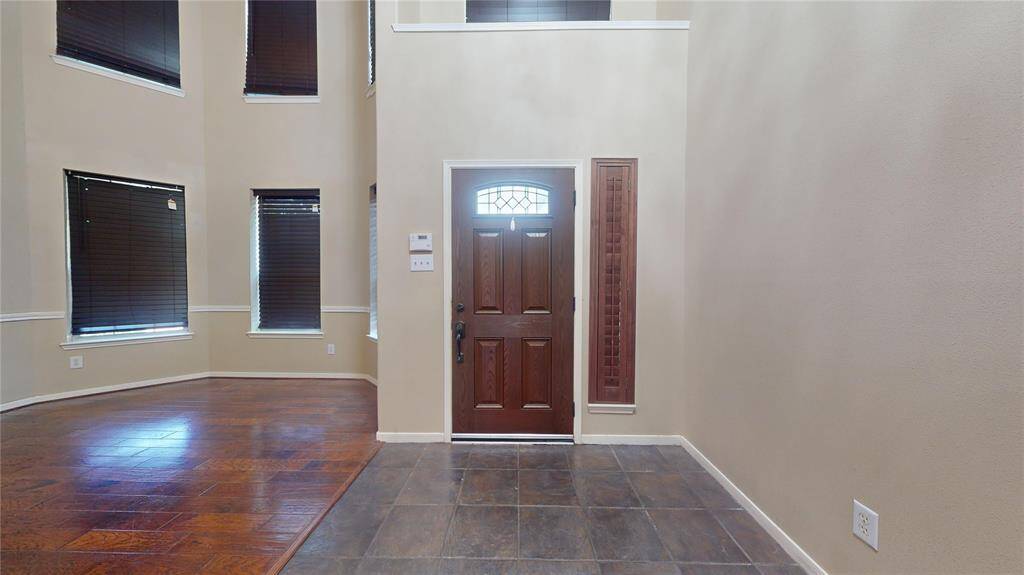 Welcoming entry with high ceilings and elegant wood floors.