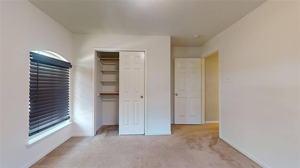 Bright upstairs guest bedroom with ample closet space.