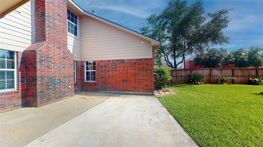 Charming back patio with a view of the private, fenced yard.