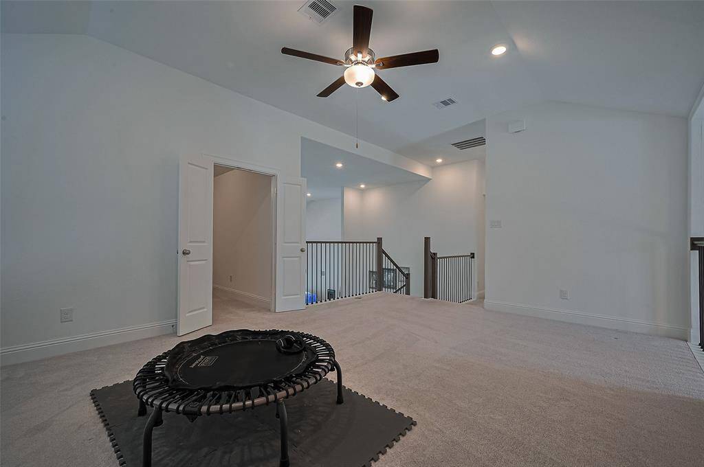 A narrowed view of the game room and the adjacent media room.