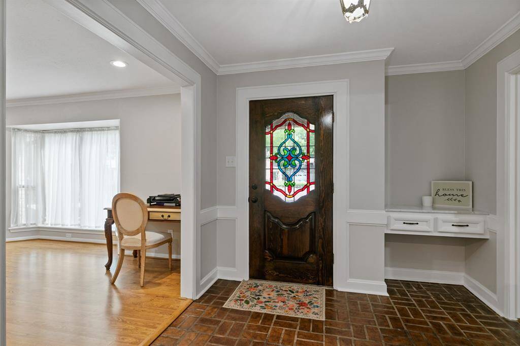 A beautiful wooden door featuring stained glass accents.