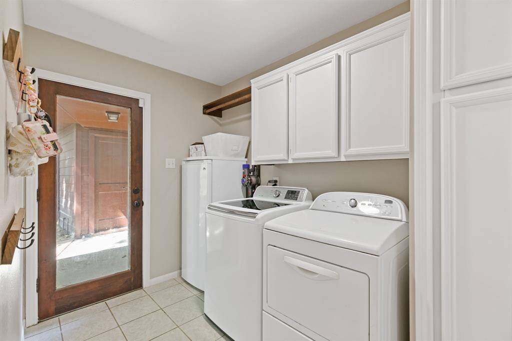 Large utility room with extra storage and room for an extra refrigerator or freezer.