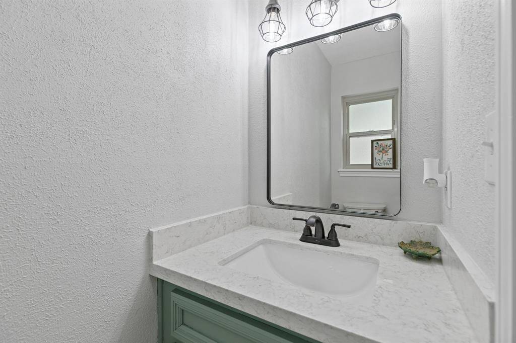 Powder room conveniently located off of the utility room.