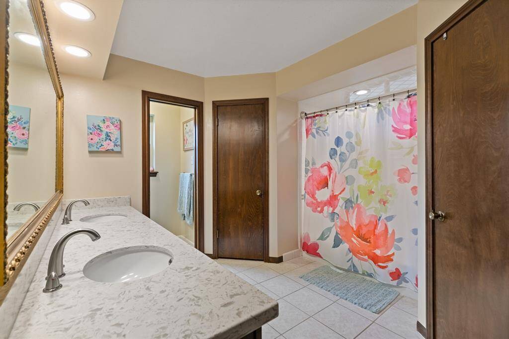 Primary bath with dual sinks, walk in closets, walk in shower and private water closet.
