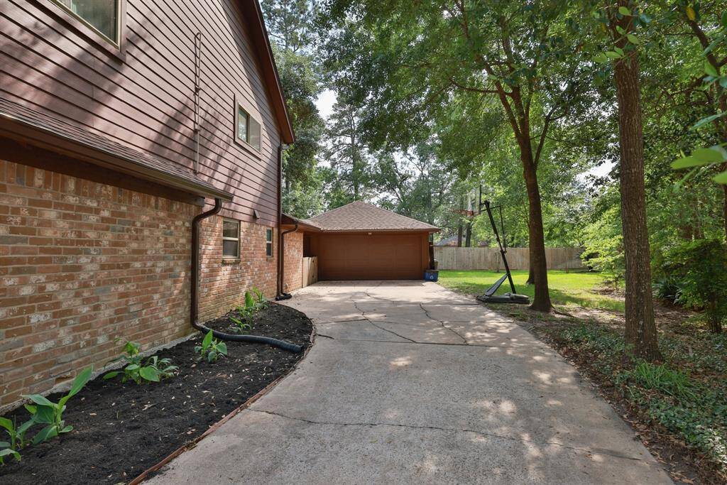 Long driveway to the 2-car detached garage with a workbench and built in storage.