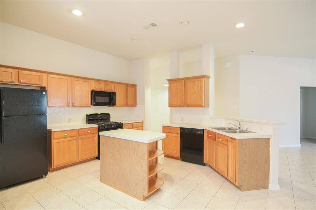 bright, open island-kitchen with Kenmore appliances & refrigerator