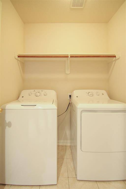 laundry room in house adjacent to garage with washer & dryer