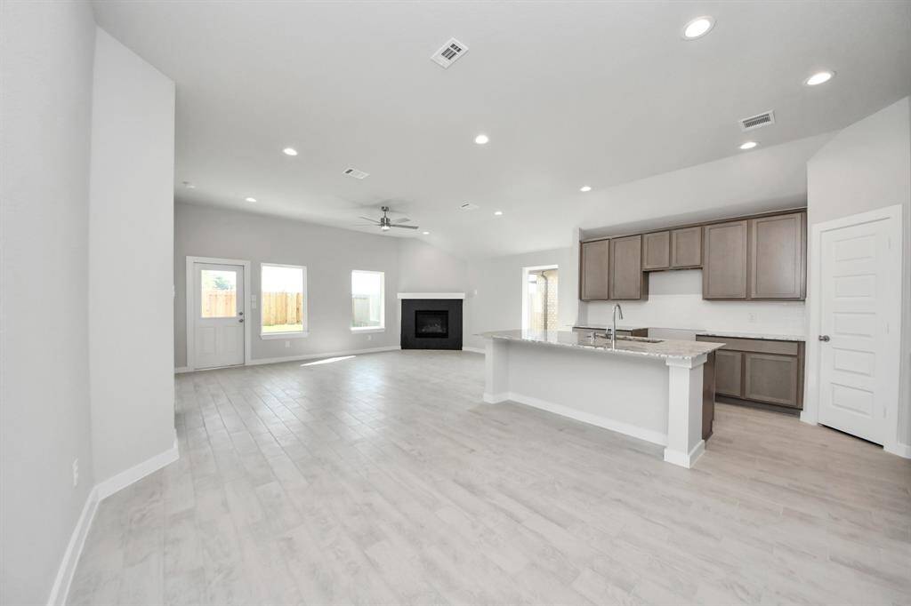 All of this overlooks your expansive family room, creating a perfect space for culinary delights and family gatherings. Sample photo of completed home with similar floor plan. Actual colors and selections may vary.