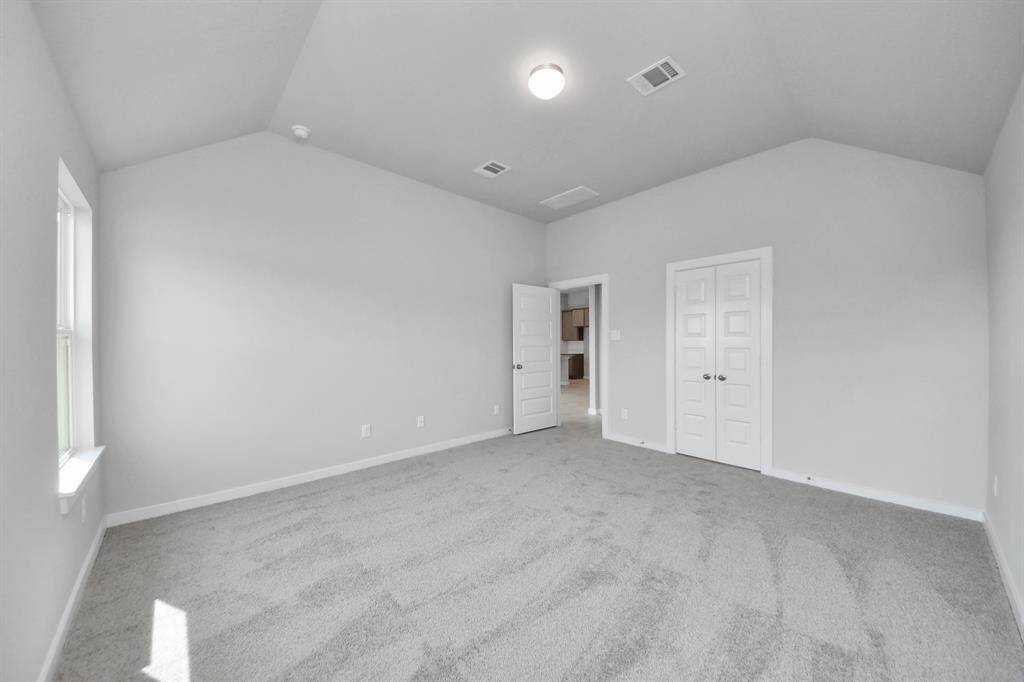 Come and unwind after a long day in this magnificent primary suite! This spacious room features plush carpet, warm paint, high ceilings and large windows with privacy blinds. Sample photo of completed home with similar floor plan. Actual colors and selections may vary.