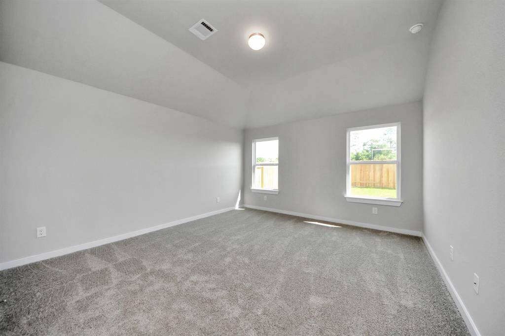 Come and unwind after a long day in this magnificent primary suite! This spacious room features plush carpet, warm paint, high ceilings and large windows with privacy blinds. Sample photo of completed home with similar floor plan. Actual colors and selections may vary.