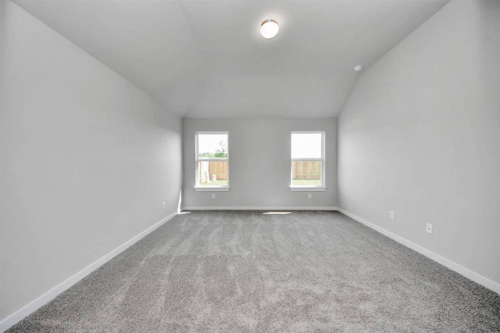 Another perspective unveils a comprehensive view of the serenity and comfort this primary suite offers. Sample photo of completed home with similar floor plan. Actual colors and selections may vary.