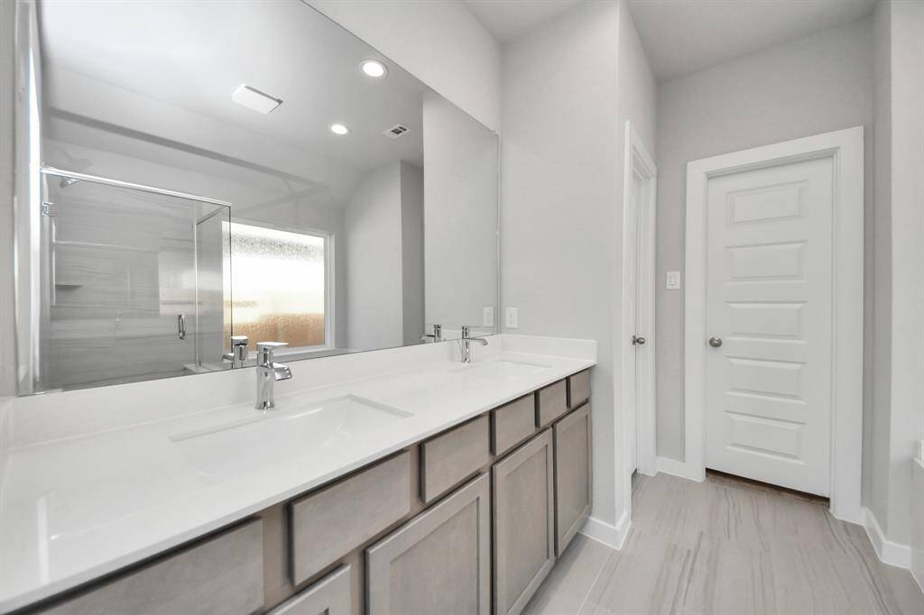 Indulge in a spa-like retreat within the confines of this primary bathroom! Sample photo of completed home with similar floor plan. Actual colors and selections may vary.