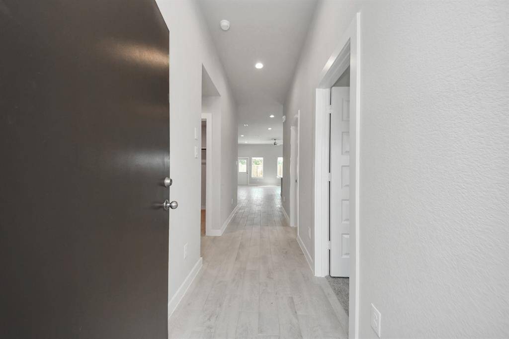 As you step into the threshold of this luxurious home, you'll soon be welcomed by an elegant glass door (to be installed). Inside, soaring ceilings amplify the spaciousness, while the refined wood-look tile flooring and oversized baseboards exude sophistication and charm.Sample photo of completed home with similar floor plan. Actual colors and selections may vary.