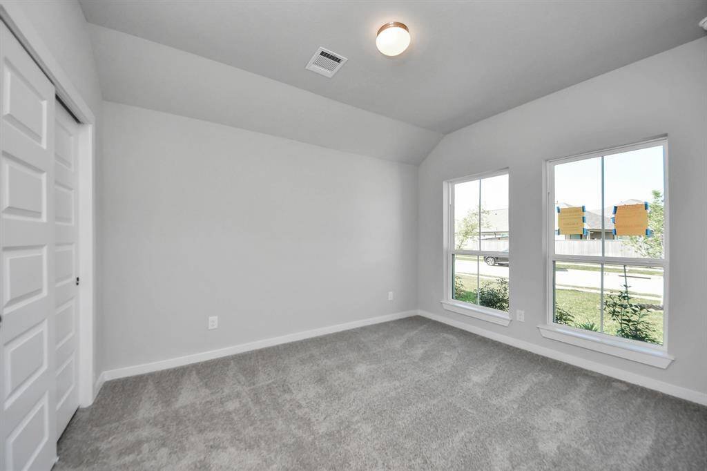 Generously sized secondary bedrooms featuring spacious closets, soft and inviting carpeting underfoot, large windows allowing plenty of natural light, and the added touch of privacy blinds for your personal retreat. Sample photo of completed home with similar floor plan. Actual colors and selections may vary.