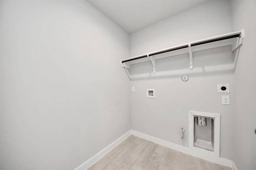 A perfect blend of functionality and comfort. Capture the essence of easy living with a first-floor laundry room, thoughtfully equipped with shelving for effortless organization. Both electric and gas connections available. Sample photo of completed home with similar floor plan. Actual colors and selections may vary.