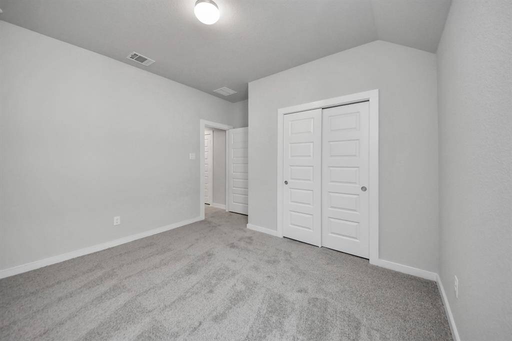 Generously sized secondary bedrooms featuring spacious closets, soft and inviting carpeting underfoot, large windows allowing plenty of natural light, and the added touch of privacy blinds for your personal retreat. Sample photo of completed home with similar floor plan. Actual colors and selections may vary.