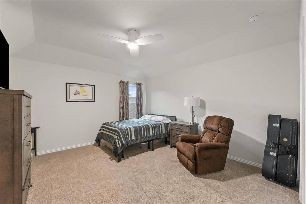 Fourth bedroom with walk-in closet and smart ceiling fan