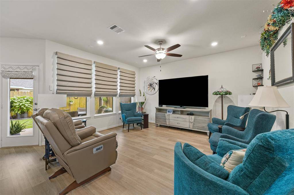 Living room with custom remote blinds.