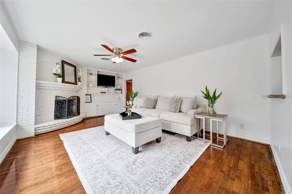 Gorgeous family room with gas fireplace and picturesque window overlooking the beautiful pool!