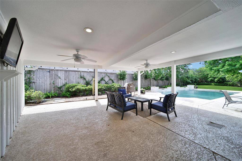 Spacious covered patio with pool views.
