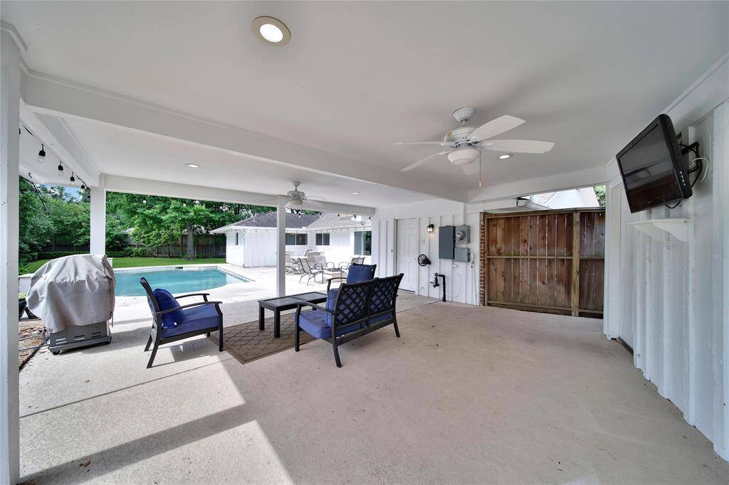 Spacious covered patio with pool views.
