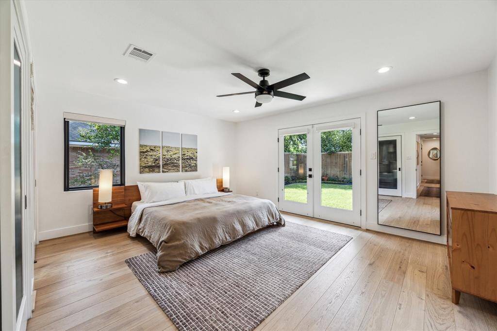 The spacious primary suite is a true retreat, offering direct access to the backyard and an ensuite bath.