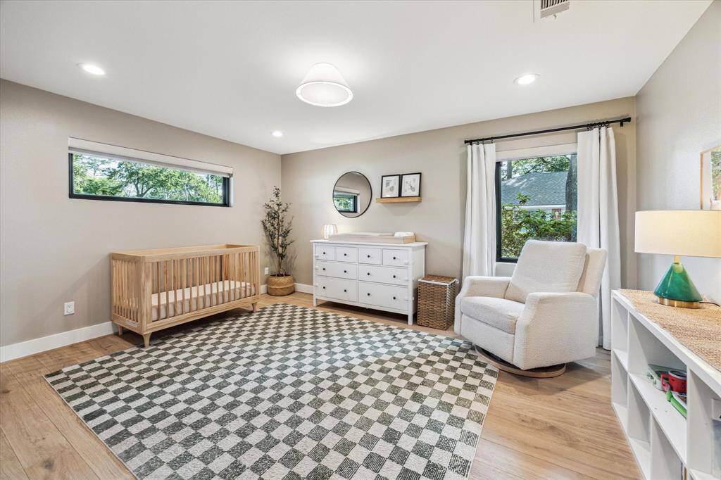 Secondary bedroom with recessed lighting, large windows, engineered wood floors and a closet.