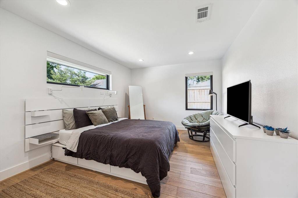 Third bedroom with recessed lighting, engineered wood floors and closet.