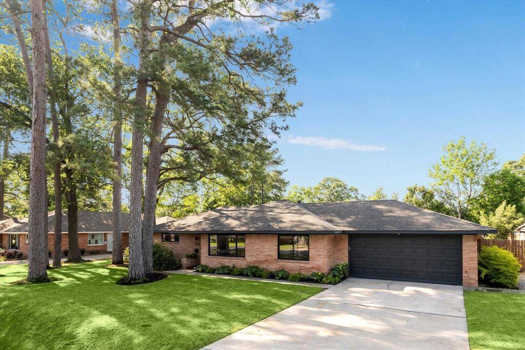 Double wide driveway leads to an attached 2-car garage with a Smart home garage door opener.
