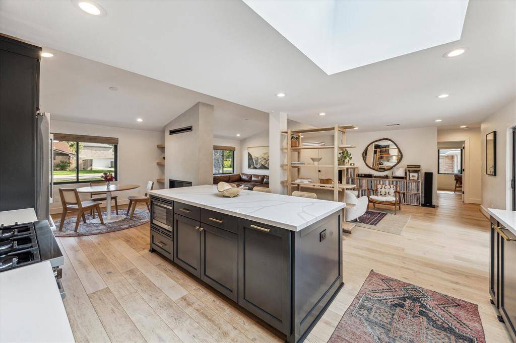 The kitchen features quartz counters and custom-made cabinets with unlacquered brass hardware from Rejuvenation.