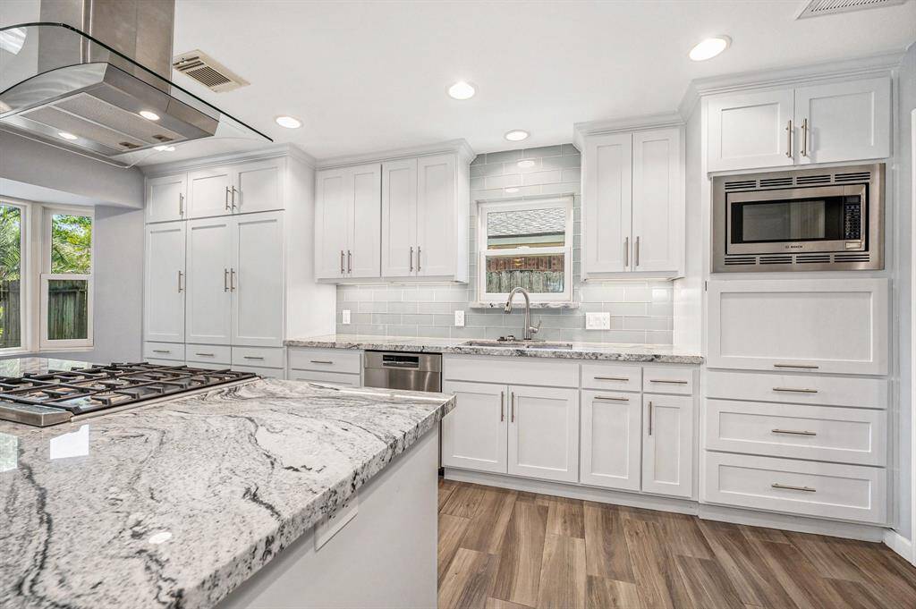 Beautiful granite counters, Bosch stainless appliances and storage galore! Window over double kitchen sink with a touch faucet . This kitchen is truly a Chef's delight.