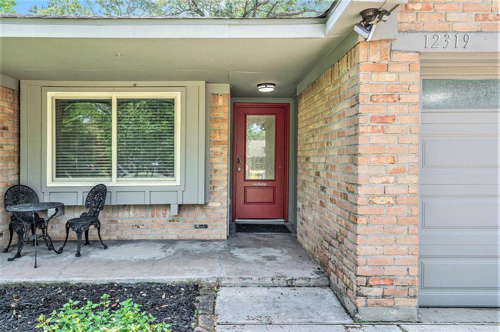 Custom front door with rain glass escorts you to this one story updated home.