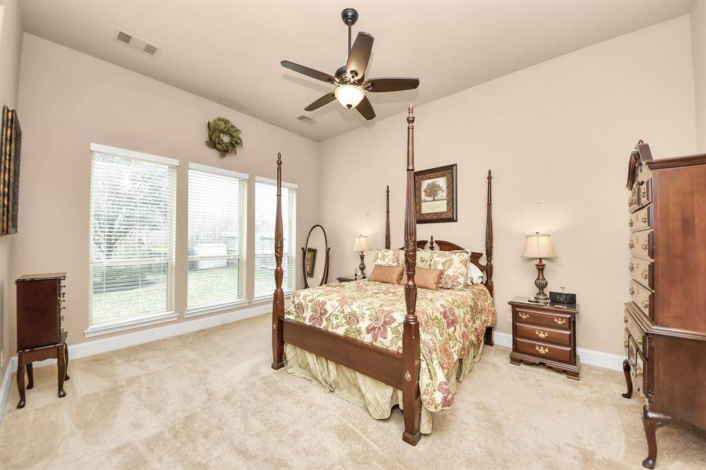 The Primary bedroom is spacious and bright with large windows which allow for a clear view of the backyard.