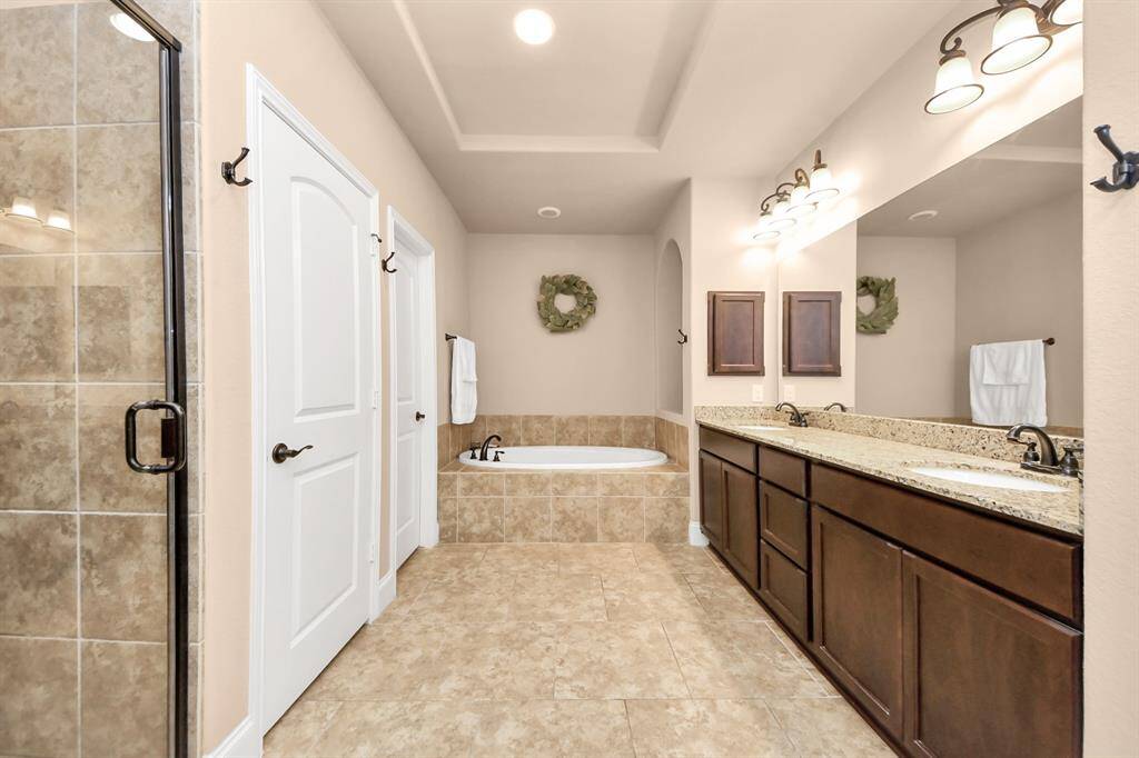 The large Primary ensuite bathroom includes a huge walk-in closet, soaking tub, separate shower, double sinks, and a linen closet.