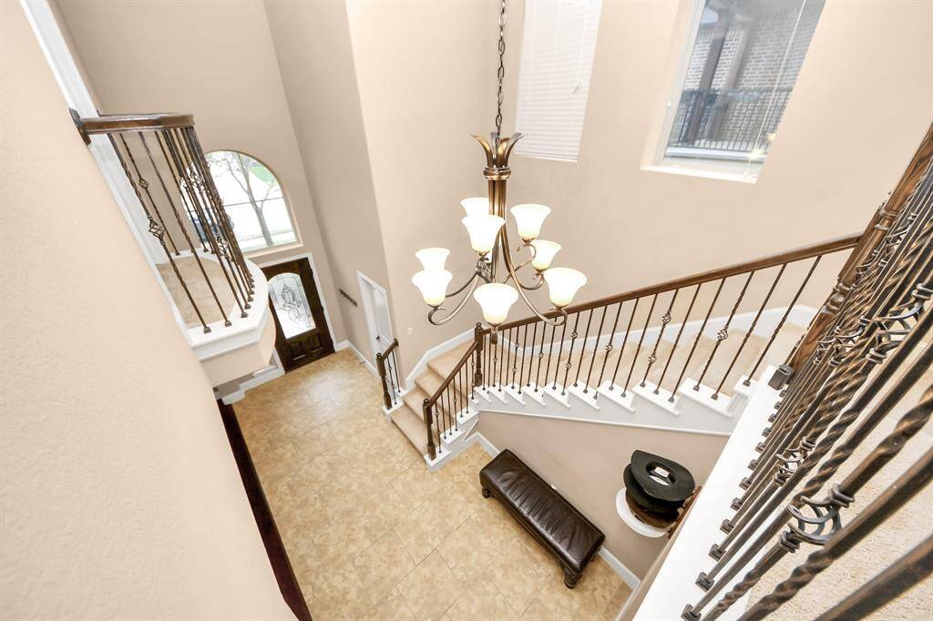 The view from upstairs shows how elegant the front foyer is, and notice the Juliet balcony off of the Upstairs Office!