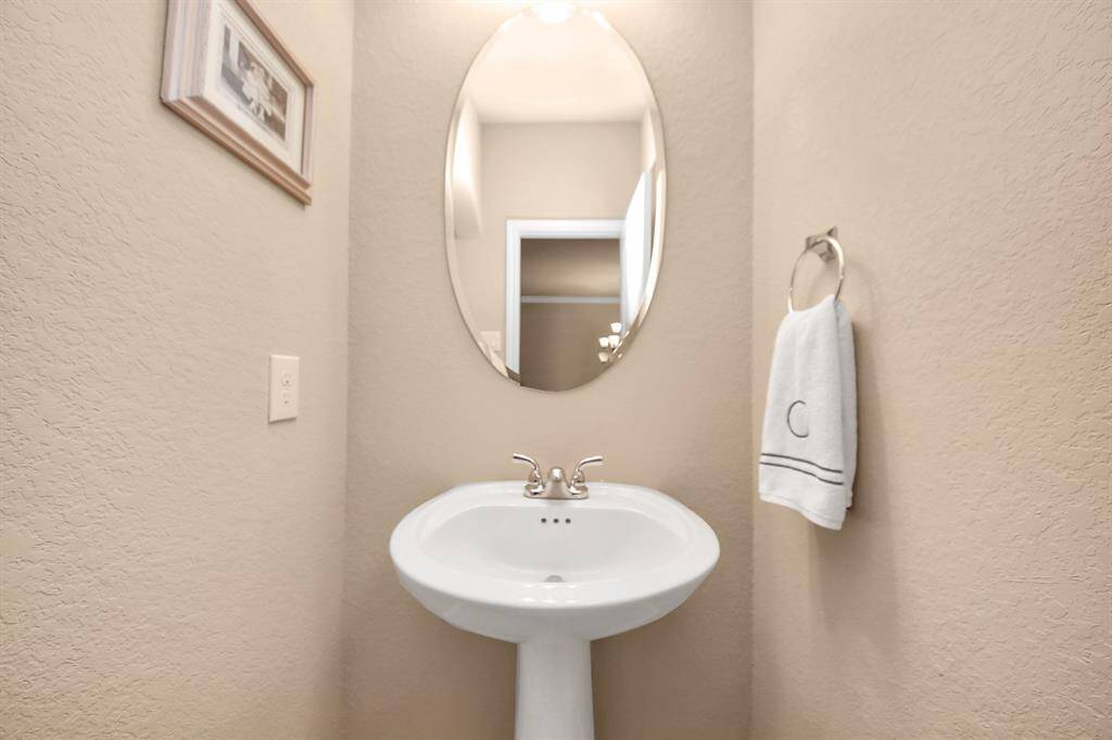 Spacious powder room located off of the entryway.