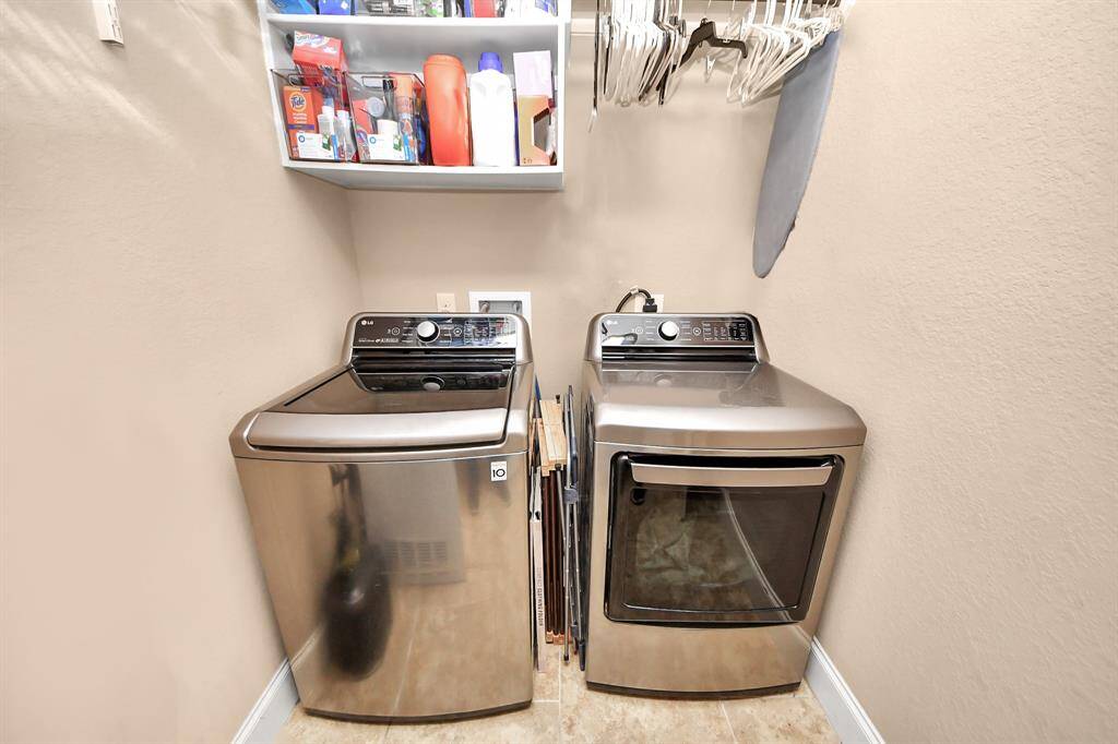 Large, interior laundry room located near the garage, off of the kitchen.