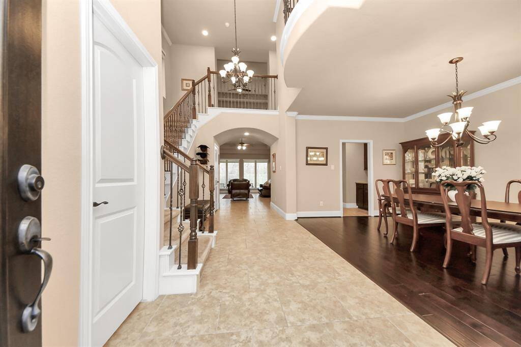 Upon entry, you'll find a bright, 2-story foyer with seating area, Formal dining room to your right and spacious powder room on the left.