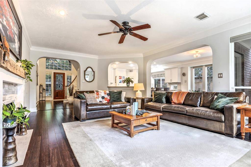 This spacious family room feels both elegant and comfortable, with arched doorways, a breakfast bar for casual seating, and an open flow to the kitchen and breakfast room.