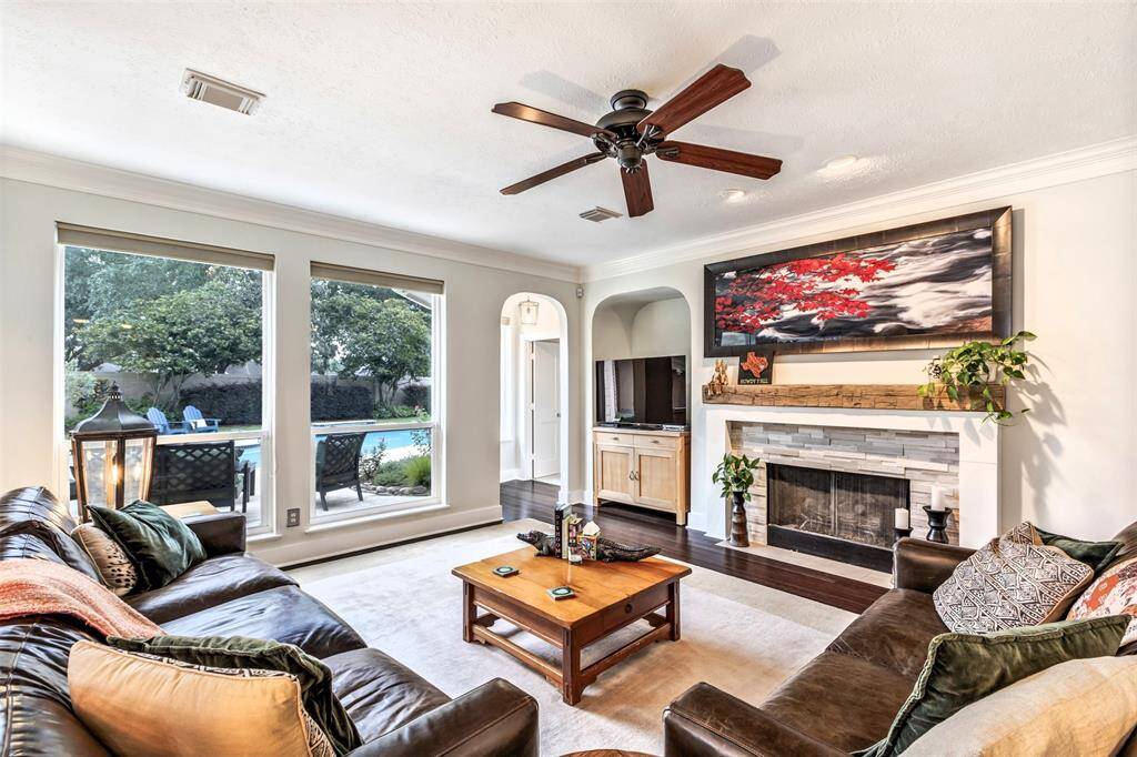 This angle shows off one of the room’s best features: a wall of windows that frames the backyard and fills the space with light. The gas fireplace adds warmth and a focal point for cozy evenings in.