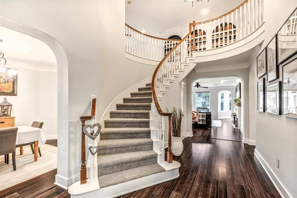 From this angle, you can see how the home opens up beautifully. Formal dining to the left, family room straight ahead, and that show-stopping curved staircase is just begging for holiday garland or prom photos!