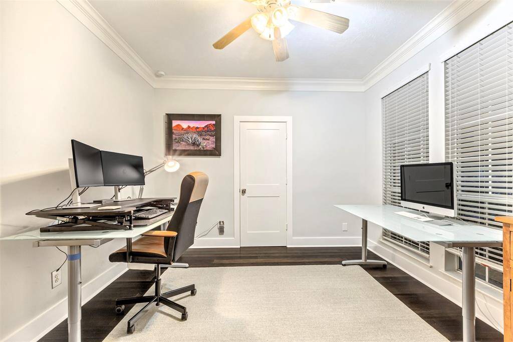 A flexible space that is currently being used as a home office. It could even be used as a formal living room or exercise room.
